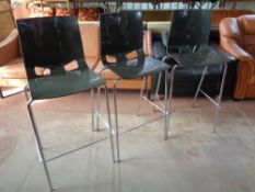 A set of three Nowy Styl moulded plastic bar chairs on metal legs