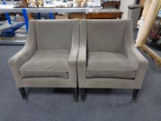 A pair of armchairs upholstered in a suede-type fabric