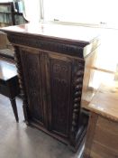 A late 19th century mahogany and walnut double door cabinet fitted a drawer above with pillar