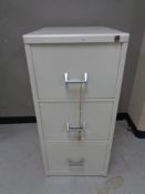 A 20th century metal three drawer filing cabinet with key