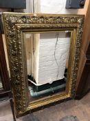 A highly ornate reproduction gilt and gesso cushion frame CONDITION REPORT: Some