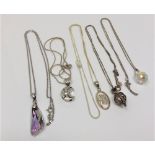 Five silver pendants on chains (5)