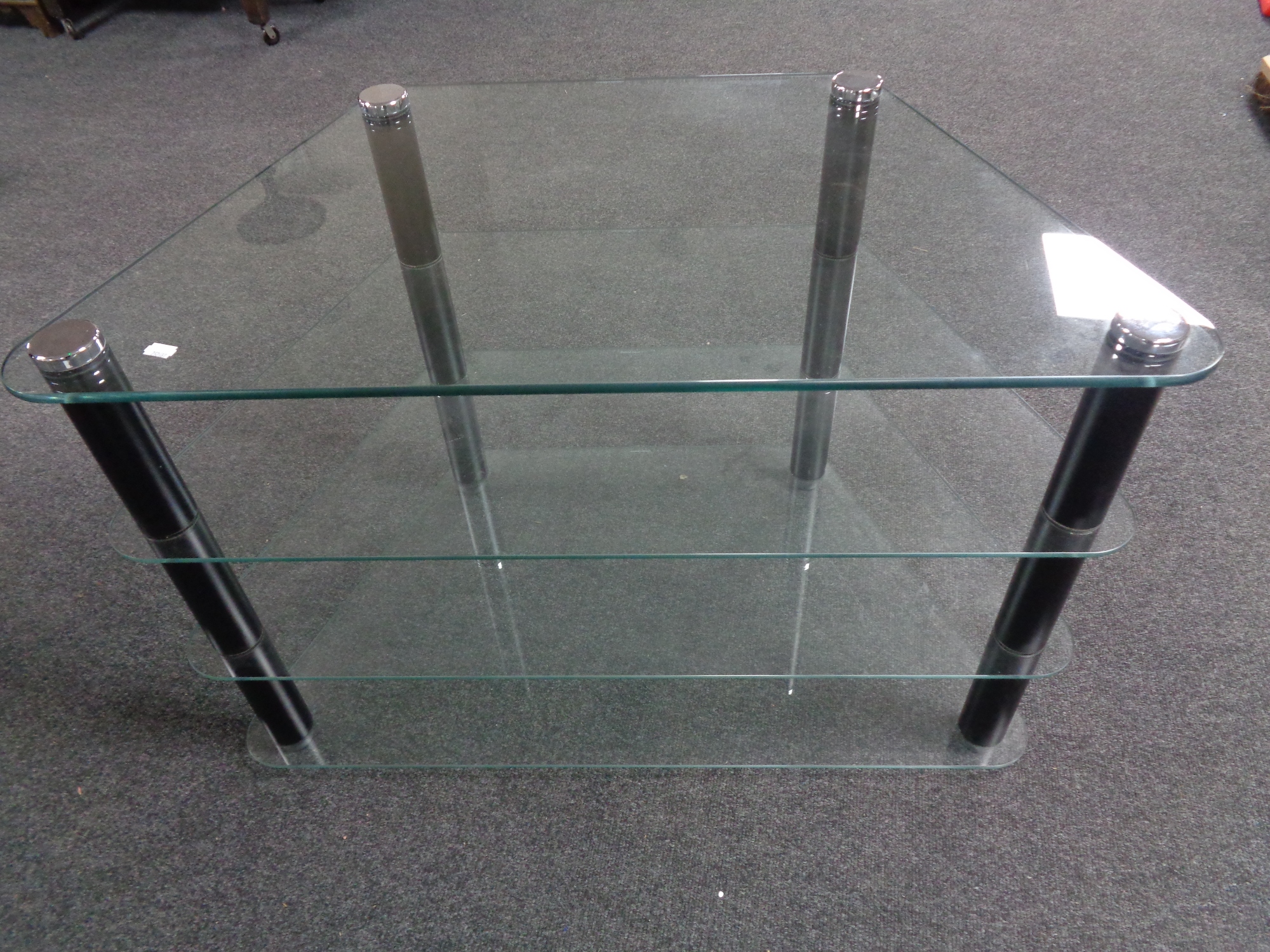 A shaped contemporary glass four-tier television stand