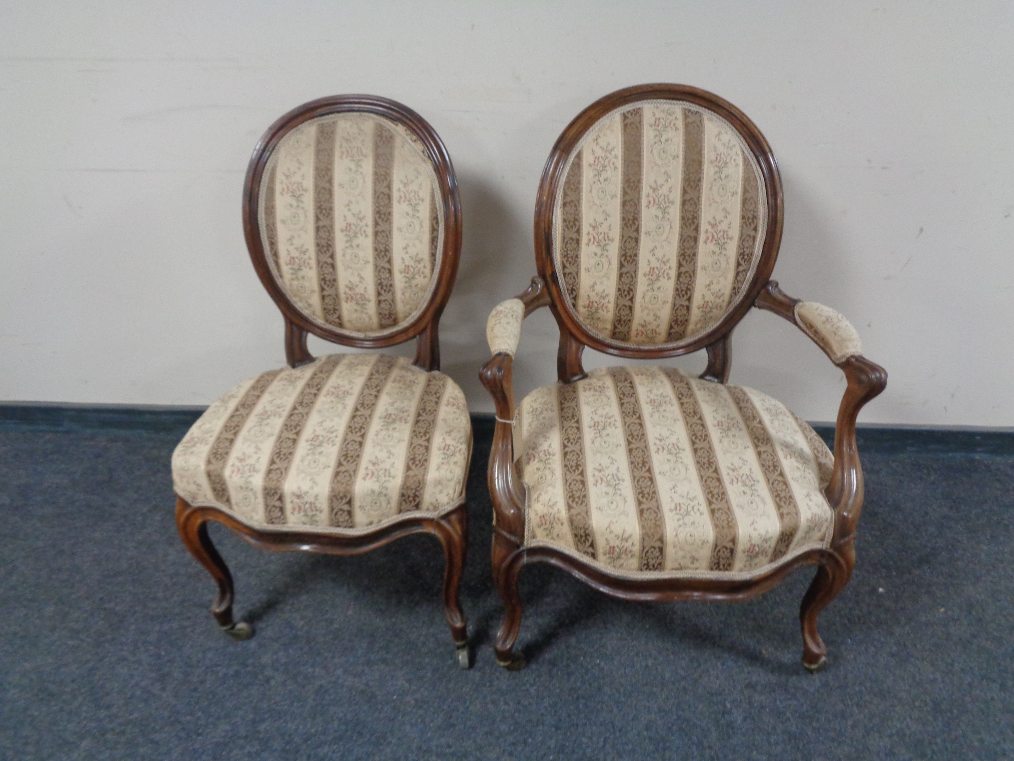 An antique walnut scroll armchair and matching salon chair