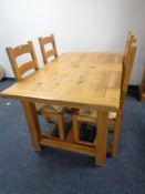 A contemporary oak refectory dining table and four rush seated ladder back chairs