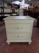 A contemporary white two drawer bedside chest