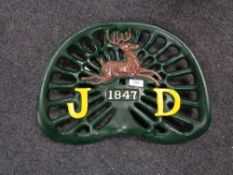 A cast iron John Deere tractor seat