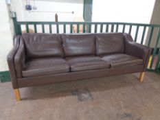 A 20th century Danish brown leather three seater settee