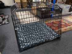 A folding metal dog cage, with liner and blanket,