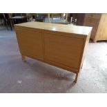 A mid 20th century double shutter front low sideboard