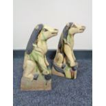 A pair of glazed pottery figures of horses,