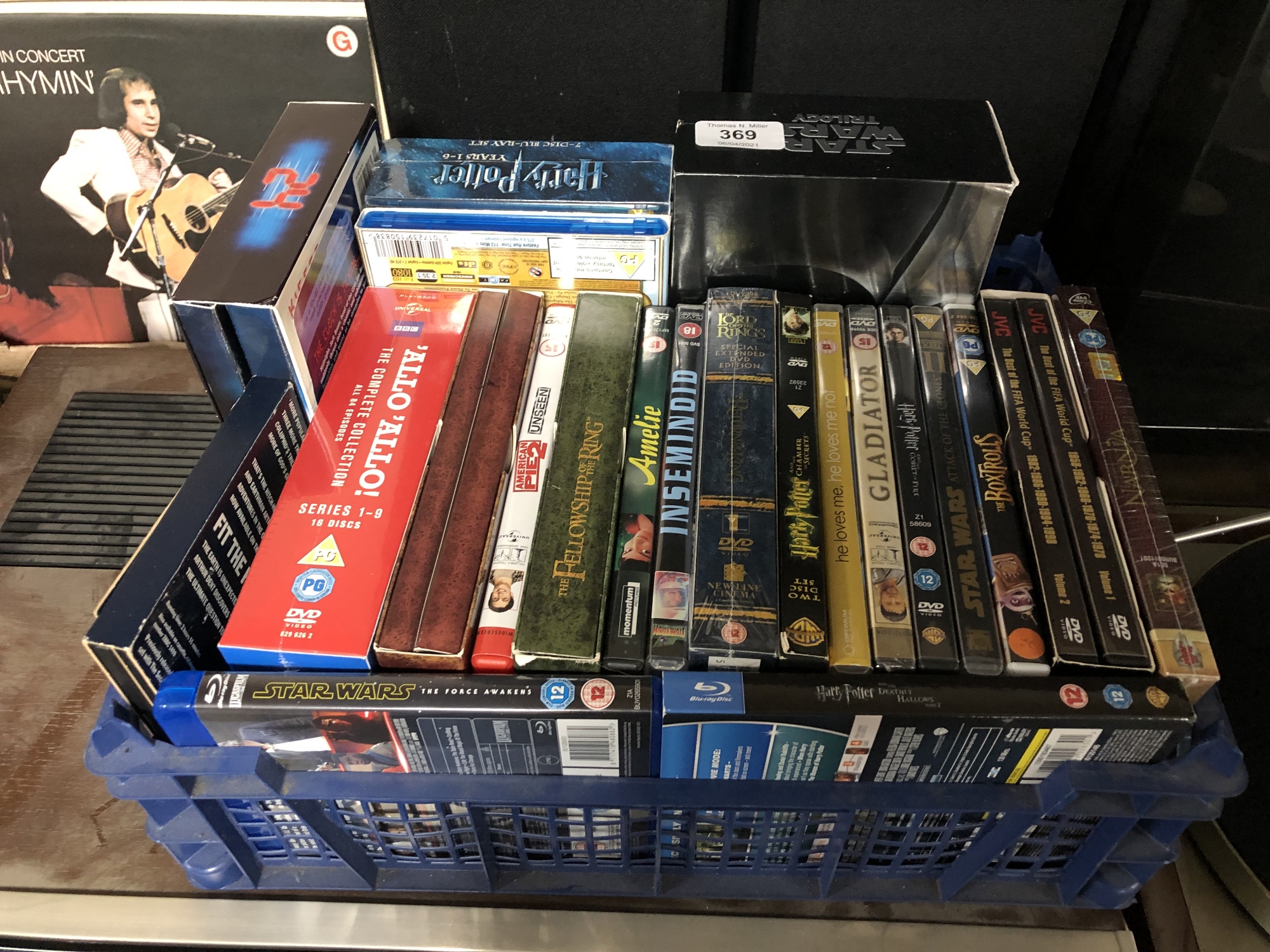 A crate of DVDs and Blu Rays including Harry Potter, Star Wars,