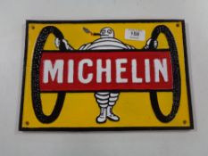 A cast iron plaque - Michelin Man with two tyres