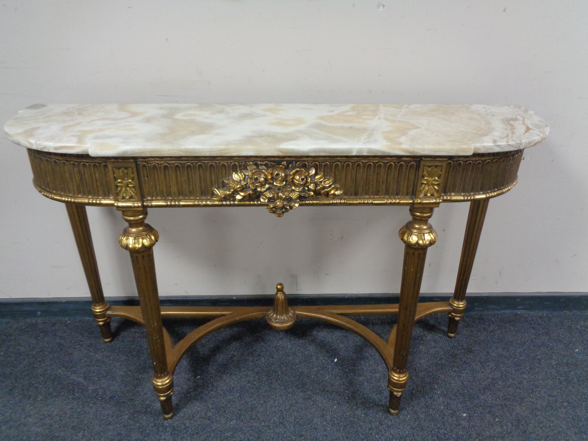 An ornate gilt marble topped console table CONDITION REPORT: 140cm wide by 42cm