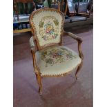 A beech framed French style salon armchair upholstered in a tapestry fabric