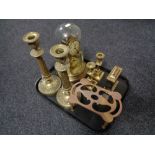 A tray of two pairs of brass candlesticks, trivet, anniversary clock under shade,