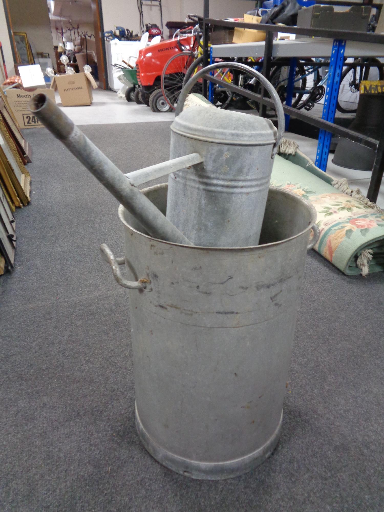 An aluminium twin handled churn, no lid, height 56cm,