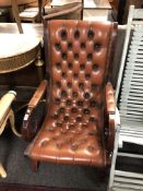 A brown buttoned leather upholstered armchair