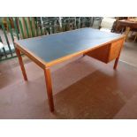 A 20th century teak single pedestal desk fitted two drawers