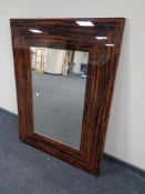 A contemporary all glass framed wall mirror