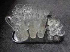 A tray containing assorted early 20th century and later glassware to include water jug, beakers,