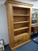 A set of contemporary oak open bookshelves fitted with four drawers beneath