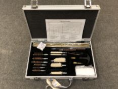 A 23-piece shotgun and rifle cleaning kit, in metal case, new and never used.