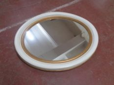 An early 20th century white and gilt oval framed mirror