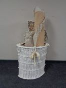 A painted wicker corner linen basket together with two circular fringed Chinese rugs and a fringed