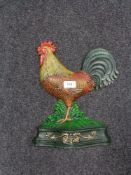 A cast iron doorstop modelled as a cockerel