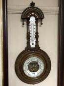 An Edwardian barometer with circular enamelled dial