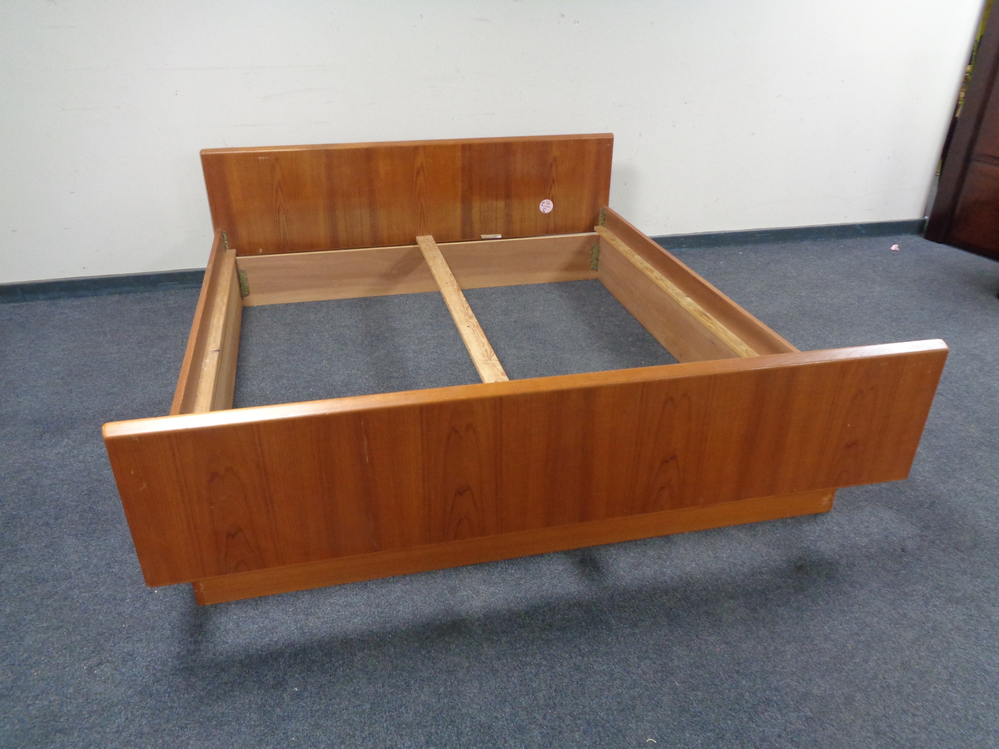 A mid 20th century teak 6' bed frame