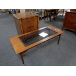 A 20th century teak coffee table and a walnut double door record cabinet