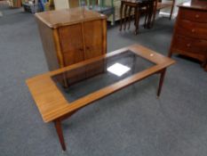 A 20th century teak coffee table and a walnut double door record cabinet