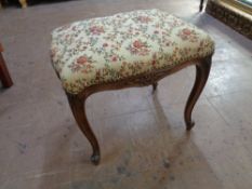 A 20th century French style beech dressing table stool upholstered in a floral tapestry fabric