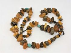 A bead necklace strung with unpolished amber and other stones, length approx.