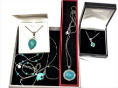 Five silver and turquoise necklaces/pendants.