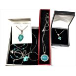 Five silver and turquoise necklaces/pendants.