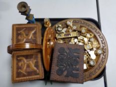 A tray of a collection of miniature brass desk clocks, wooden tourist pates,