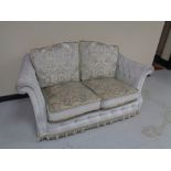 A floral dralon two seater settee