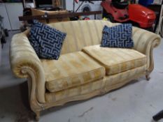 A wood framed Duresta two seater settee in gold striped fabric CONDITION REPORT: