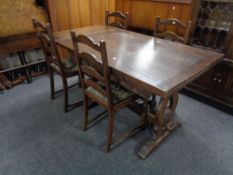 A Jaycee Oak refectory dining table together with a set of four oak ladder back chairs