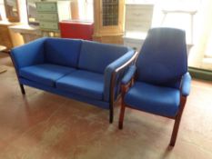 A late 20th century stained beech framed two seater settee with blue cushions and similar armchair