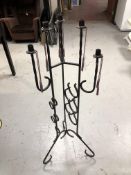 A wrought iron floor standing six-way candle holder
