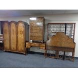 A four piece Palatial Furniture walnut bedroom suite comprising of triple door dome topped wardrobe,