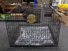 A folding metal dog cage, with liner and blanket,