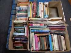 A pallet of four boxes of hardback and paperback books - novels,