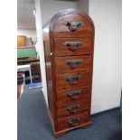 An eastern hardwood dome topped seven drawer chest with heavy metal drop handles