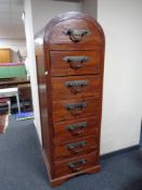 An eastern hardwood dome topped seven drawer chest with heavy metal drop handles