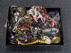 A leather tray of assorted costume jewellery